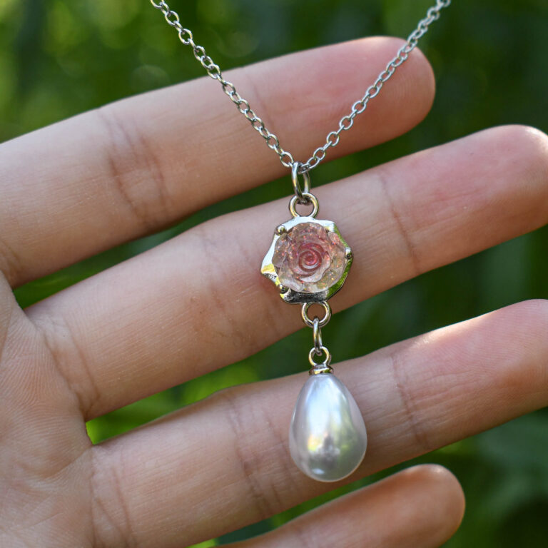 Roosa läikiva roosiõie ja pärliga kaelakee